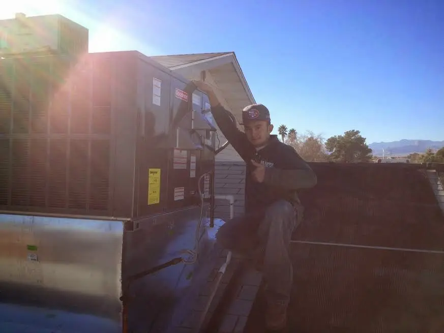 HVAC technician performing HVAC Inspection on a rooftop unit in Colonial Heights
